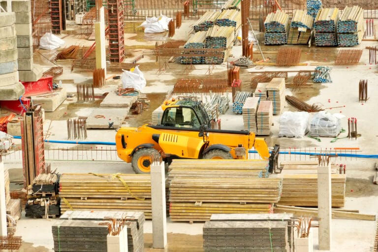 construction site of a new house with a bulldozer in the foreground